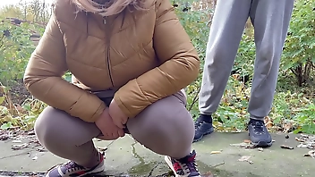 Depraved curvy MILF in leggings squats down and pisses next to me