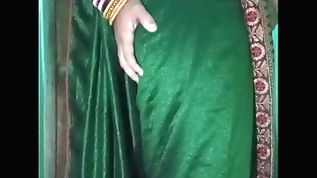 Indian gay Crossdresser Gaurisissy in Green Saree pressing her big Boobs and fingering in her ass